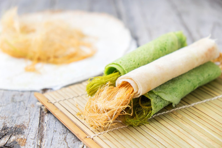 Roti sai mai (Thái Lan) là một món ăn nhẹ ngọt ngào của Thái Lan bao gồm bánh crepe hương lá dứa (roti) cuộn bên trong là kẹo bông (kẹp đường kéo sợi). Bánh áp chảo tương tự bánh crepe phwong taay và có màu xanh đặc trưng do thêm lá dứa. Món ăn được cho là có nguồn gốc từ Ayutthaya, chủ yếu trong cộng đồng người Hồi giáo. Roti sai mai thường được bán ở các quầy hàng trên đường phố. Ảnh: Insider