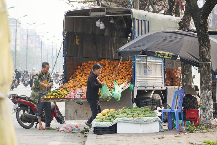 Một xe tải chở hoa quả đỗ dọc đường Giải Phóng.