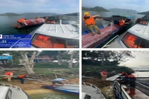 Lực lượng CSGT cứu hộ thuyền chở vật liệu bị tràn nước trên sông Đà