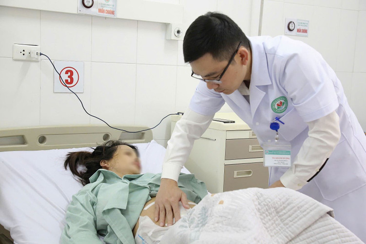 Bác sĩ cơ sở 2 thăm khám lại vết mổ cho sản phụ.