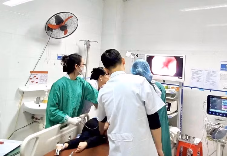 Các bác sĩ thực hiện nội soi gắp dị vật cho bệnh nhân. Ảnh BV