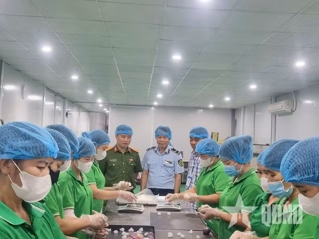 Đội Quản lý thị trường số 24 và lực lượng chức năng xã Sơn Đồng kiểm tra quy trình làm bánh Trung thu tại Công ty cổ phần Thực phẩm sức khỏe Baker Baking Food. Ảnh QĐND