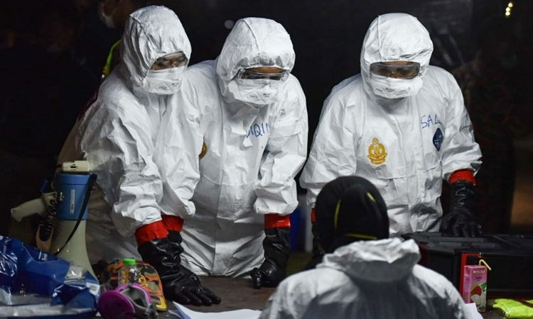 Nhân viên y tế tại sân bay Malaysia ngày 26/2, khi nước này hồi hương công dân từ Vũ Hán. Ảnh: AFP.