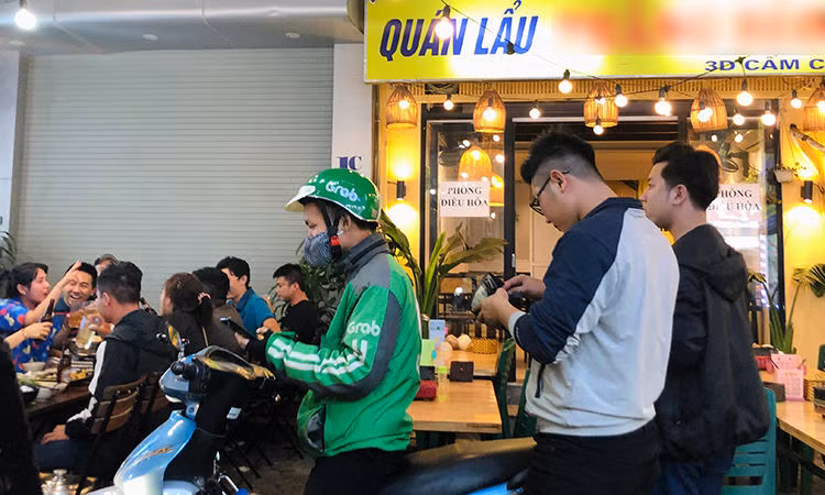 Khách hàng chọn đi&nbsp;xe ôm công nghệ sau khi nhậu xong. Ảnh: Anh Tú.