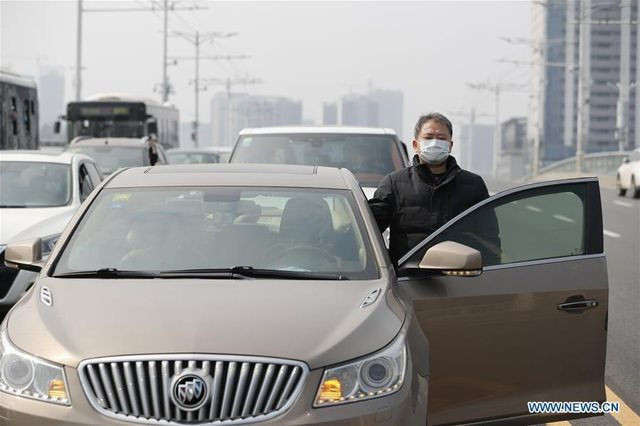 Một người đàn ông ở Vũ Hán dừng xe kéo còi tưởng niệm những người qua đời vì dịch (Ảnh: Tân Hoa Xã)