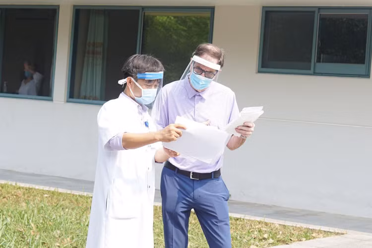 Bệnh nhân người Anh nhận giấy ra viện. Ảnh: Thanh Xuân