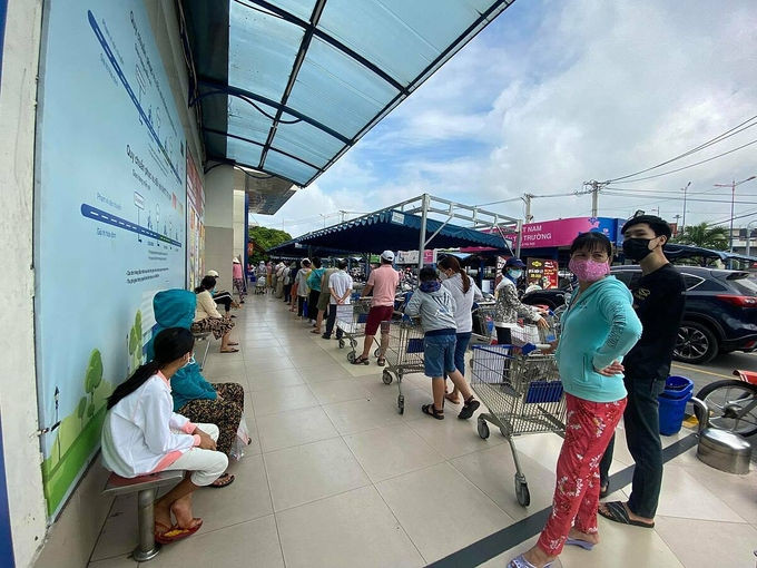 Khách xếp hàng dài chờ tới lượt vào mua hàng ở Co.opmart Xa lộ Hà Nội. Ảnh: Tấn Đạt.