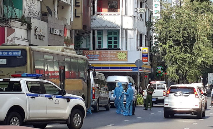 Nhân viên y tế mặc đồ bảo vệ lấy mẫu xét nghiệm của 35 người nước ngoài ở khách sạn. Ảnh: Đinh Sự.