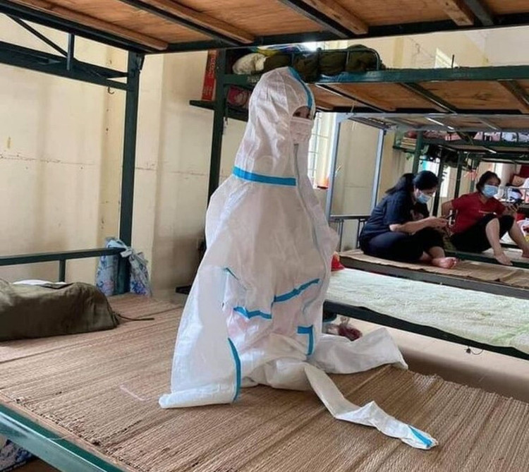 Hình ảnh một em nhỏ mặc đồ bảo hộ trong khu cách ly tập trung. (Ảnh: KT)