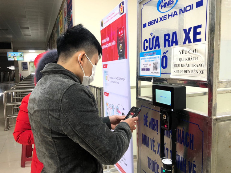 Một hành khách thực hiện khai báo y tế bằng máy quét mã QR. (Ảnh: Phong Vũ)