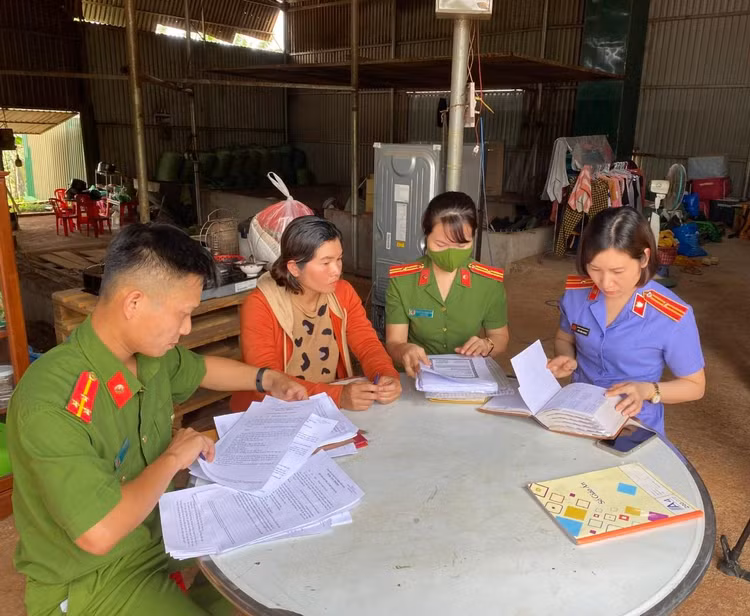 Lực lượng chức năng làm việc với bà Nguyễn Thị Thúy Kiều (áo màu cam).