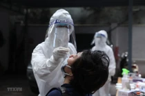 Nhân viên y tế lấy mẫu xét nghiệm. (Ảnh: TTXVN/Vietnam+)