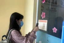 Người dân quét mã QR Code trước khi liên hệ làm việc tại Ủy ban Mặt trận Tổ quốc Việt Nam tỉnh Kiên Giang. Ảnh: Lê Sen/TTXVN