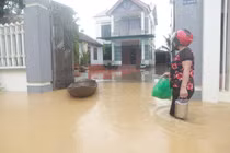 Nước dâng khiến đường ngập sâu gây khó khăn cho việc đi lại của người dân.