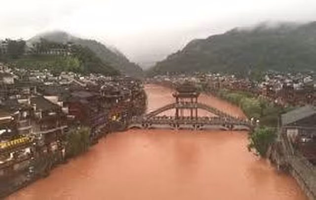 Nước lũ xối xả như thác chảy từ cửa sổ tầng 3 của tòa nhà dân cư - 3