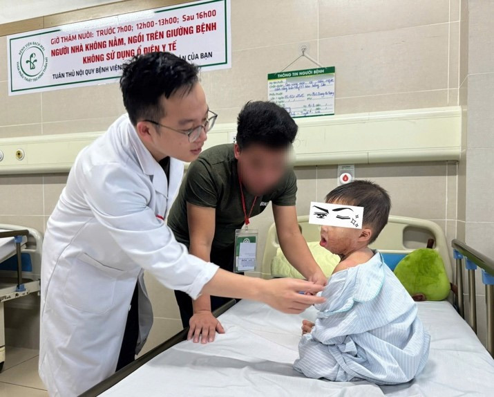 Bác sĩ kiểm tra vết thương sau phẫu thuật lần 1 cho bé - Ảnh BVCC