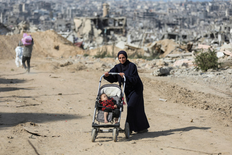 Palestinians return to devastated Jabalia following a ceasefire between Israel and Hamas in Gaza