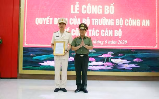 Thiếu tướng Nguyễn Hữu Cầu trao quyết định và chúc mừng Đại tá Cao Minh Huyền.