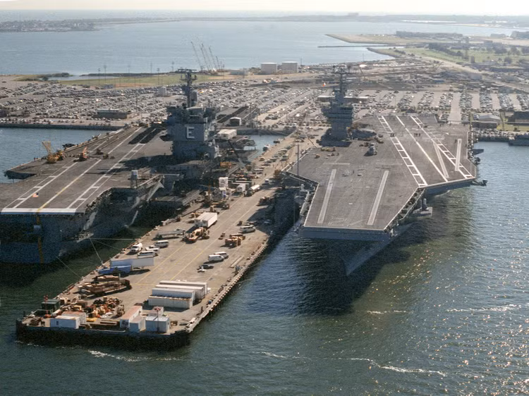 uss-enterprise-cvn-65-and-uss-abraham-lincoln-cvn-72-tied-up-at-naval-station-norfolk-on-25-september-1990-6463991.jpg